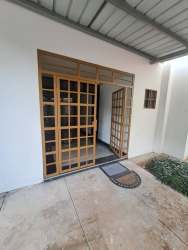 Covered entry with wooden doors to apartment building in David Panama rental listing