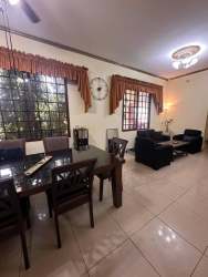 Bedroom with dark wooden bed and wardrobe, ceiling fan and air conditioning David Boquete area