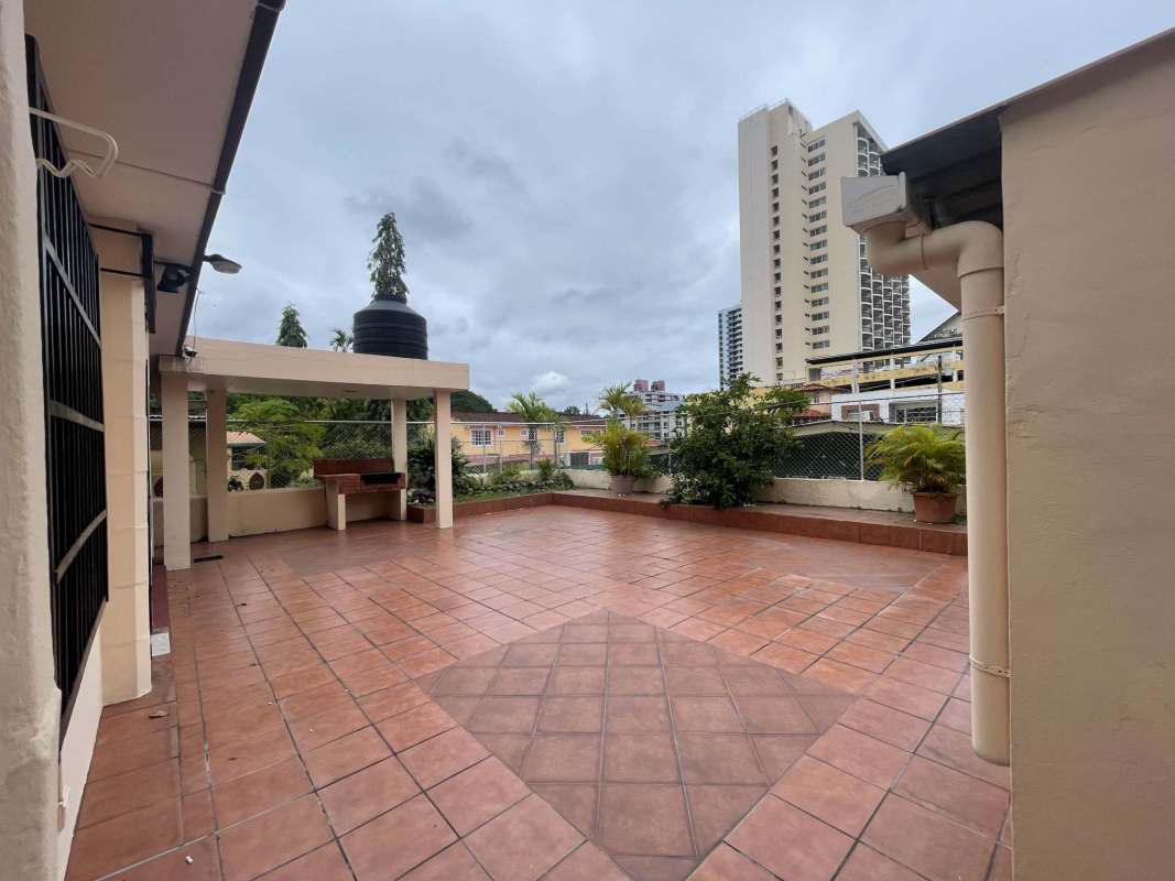 Terracotta-tiled terrace with barbecue and garden views in Betania Panama home