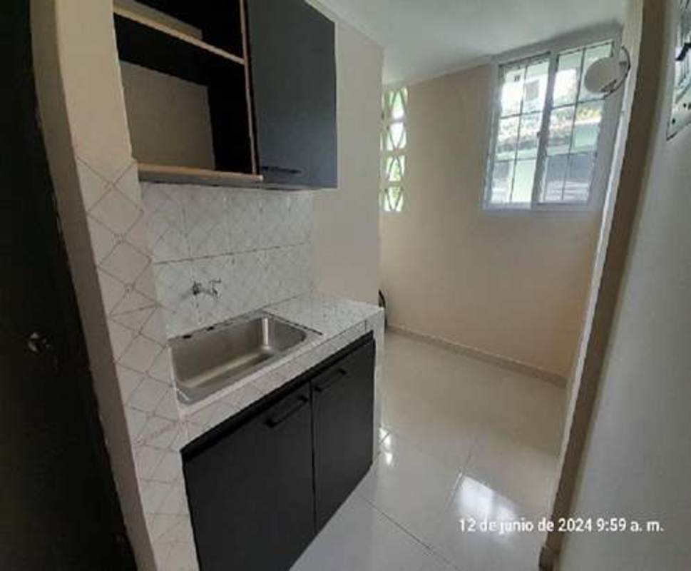 Minimalist kitchen with ceramic backsplash and cabinet storage Betania apartment Panama