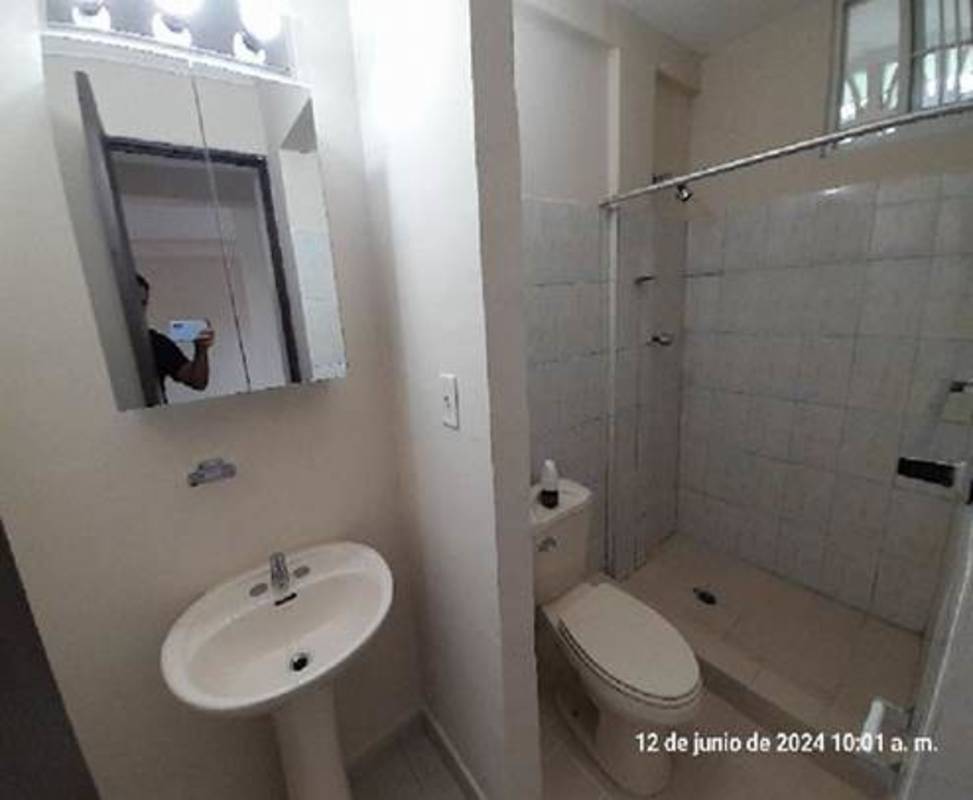 Modern bathroom with sliding glass shower and pedestal sink Betania Panama