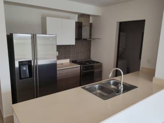 Bright integrated living-dining room with balcony access in River Valley Panama apartment