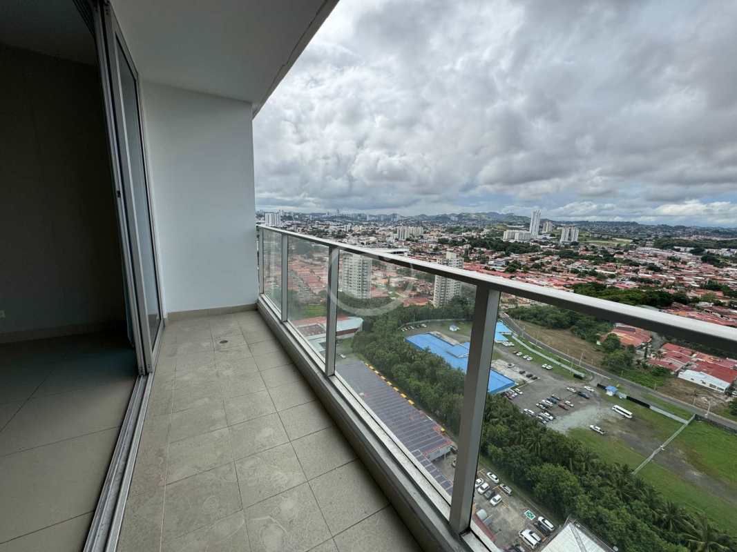 Bright open living dining area with porcelain tile floors and balcony access
