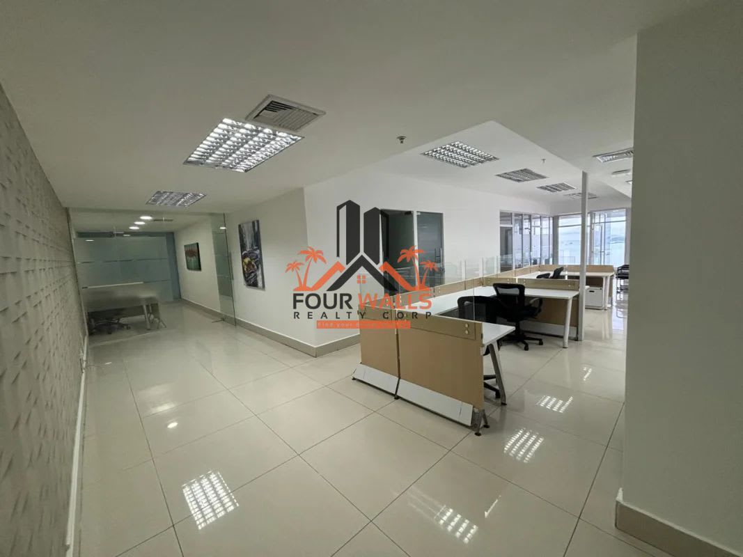 Compact kitchenette inside PH BICSA office with fridge, bar counter and seating Panama City