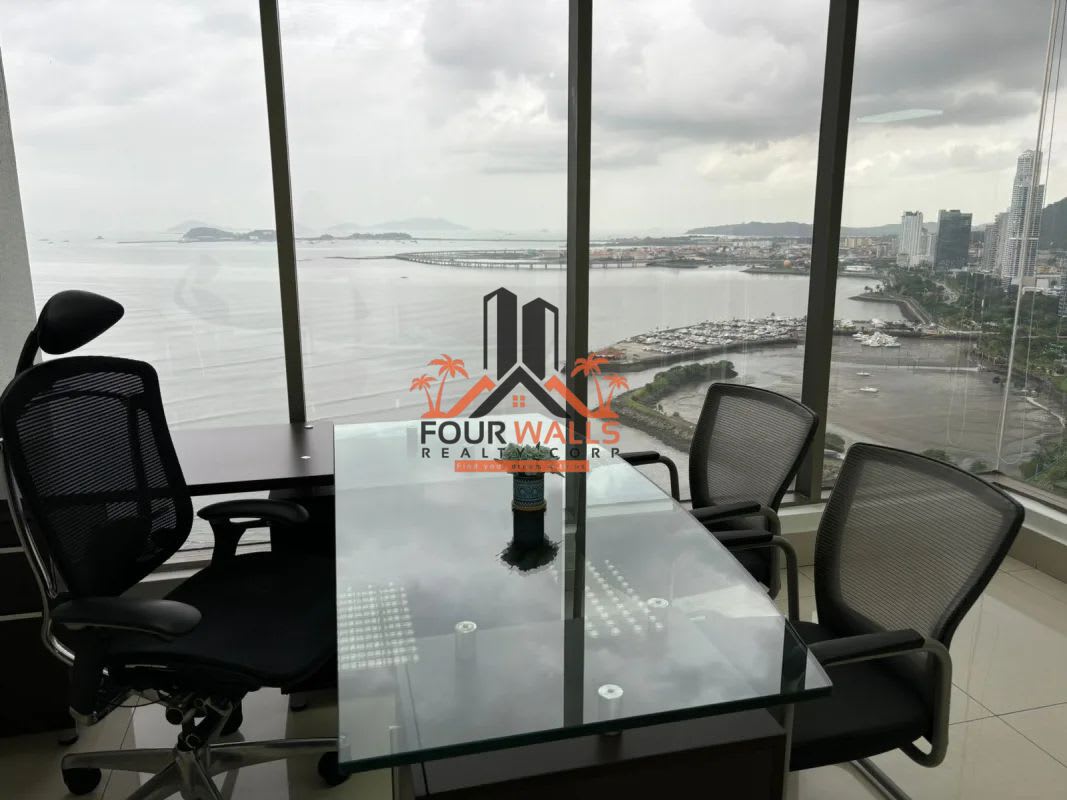 Open-plan workspace with glass partitions and natural light panoramic waterfront views in PH BICSA Panama City