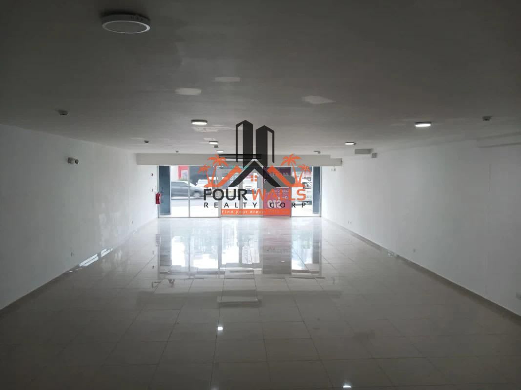 Empty commercial space large white tiled floors, recessed lighting, glass frontage in Panama City