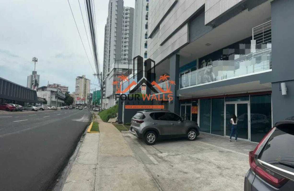 Modern commercial building with glass walls and signage along Via España Panama City