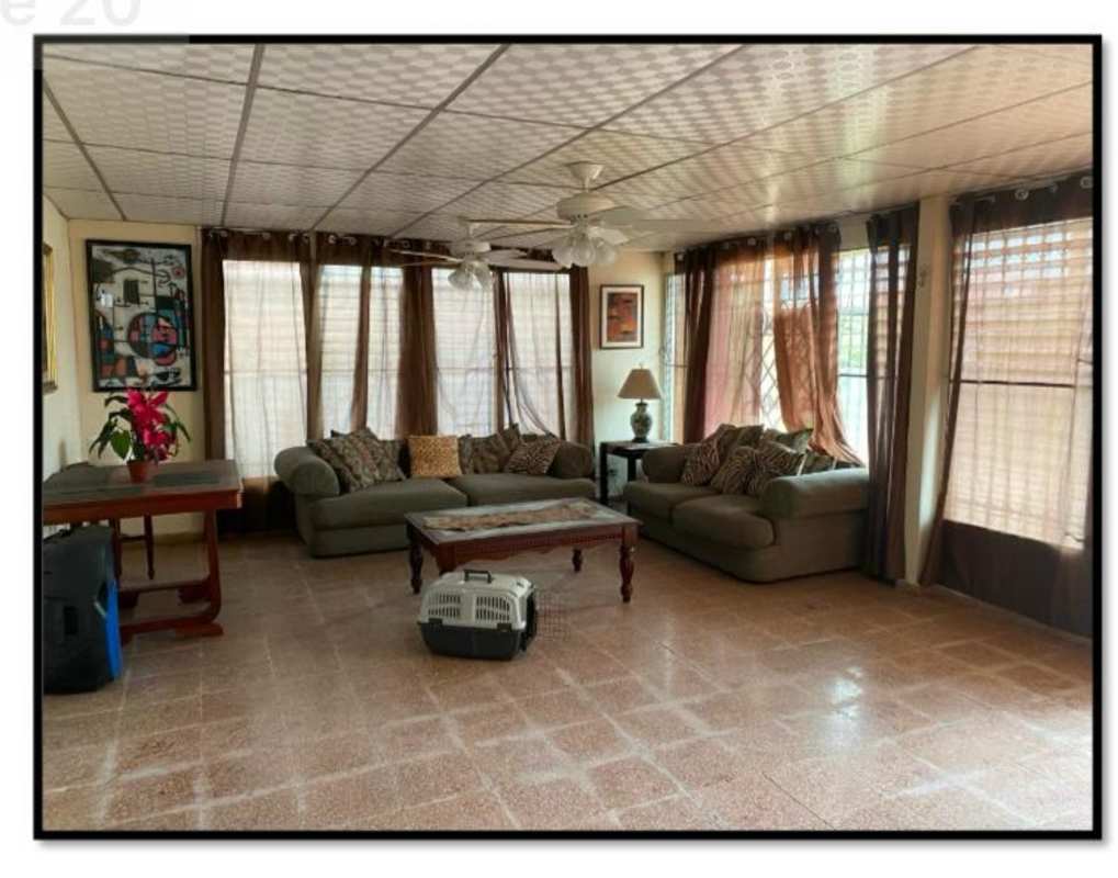 Large living space with sofas, windows, ceiling fans and tile floors in Panama house for sale