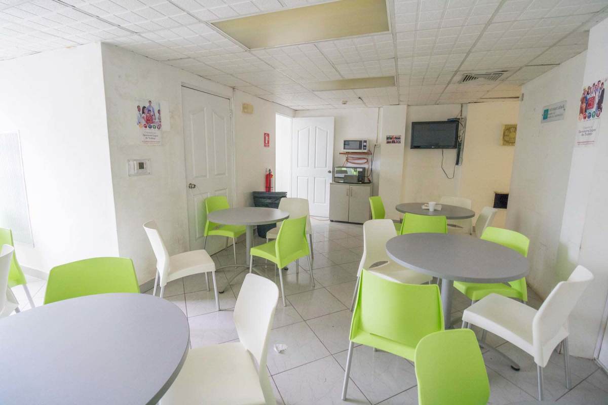 Employee lounge with dining tables and TV in commercial building Albrook Panama