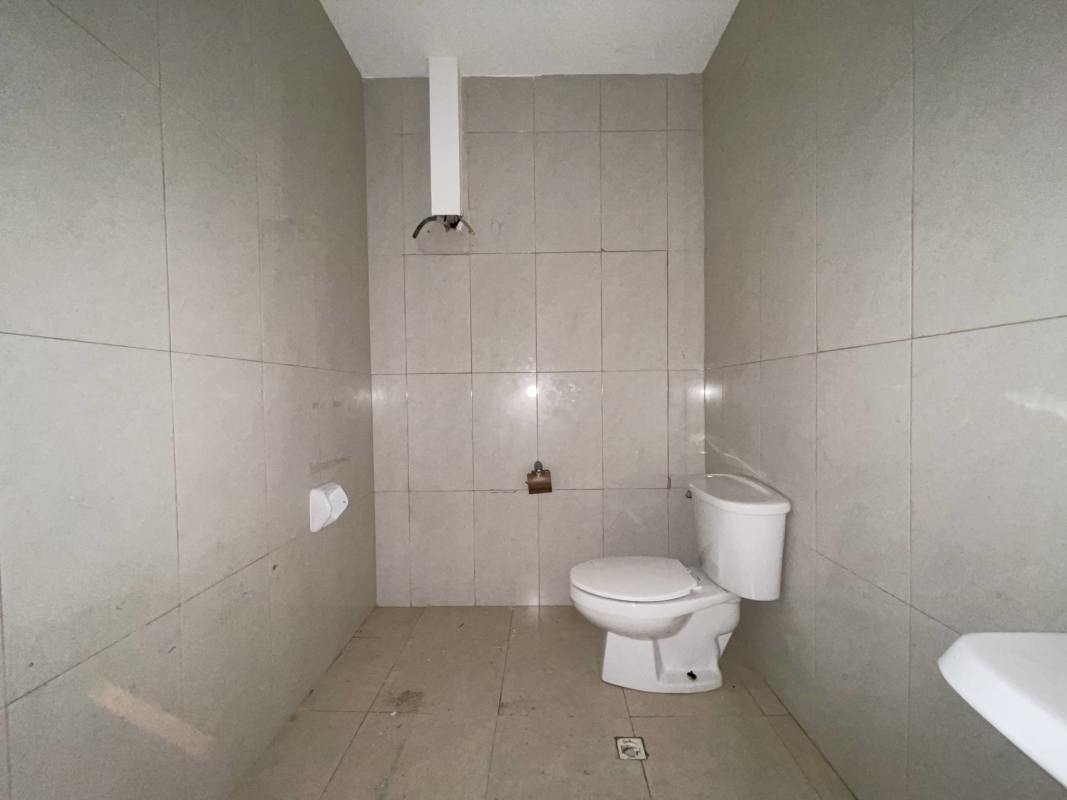 Unfinished bathroom interior with tiled walls at commercial property Panama City