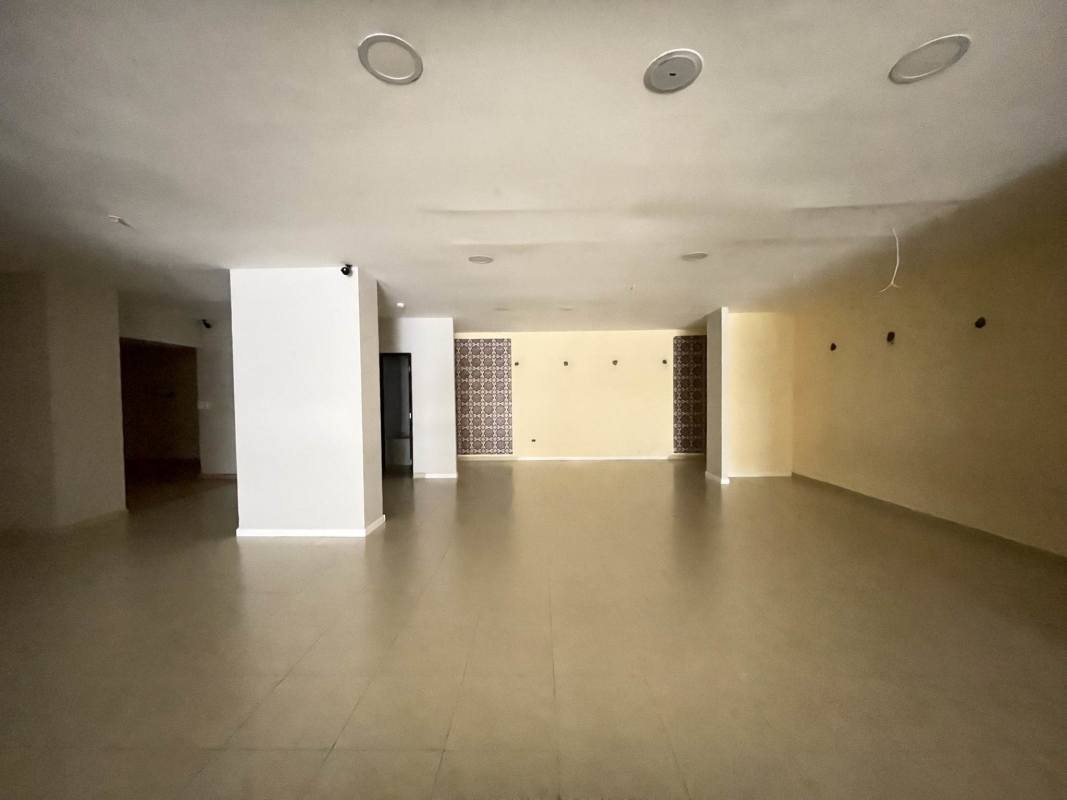Spacious empty commercial interior with tiled floor and glass storefront in PH Plaza El Cangrejo Panama City