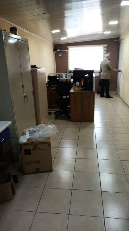 Driveway parking area with parked cars fenced lot overlooking Panama city skyline commercial