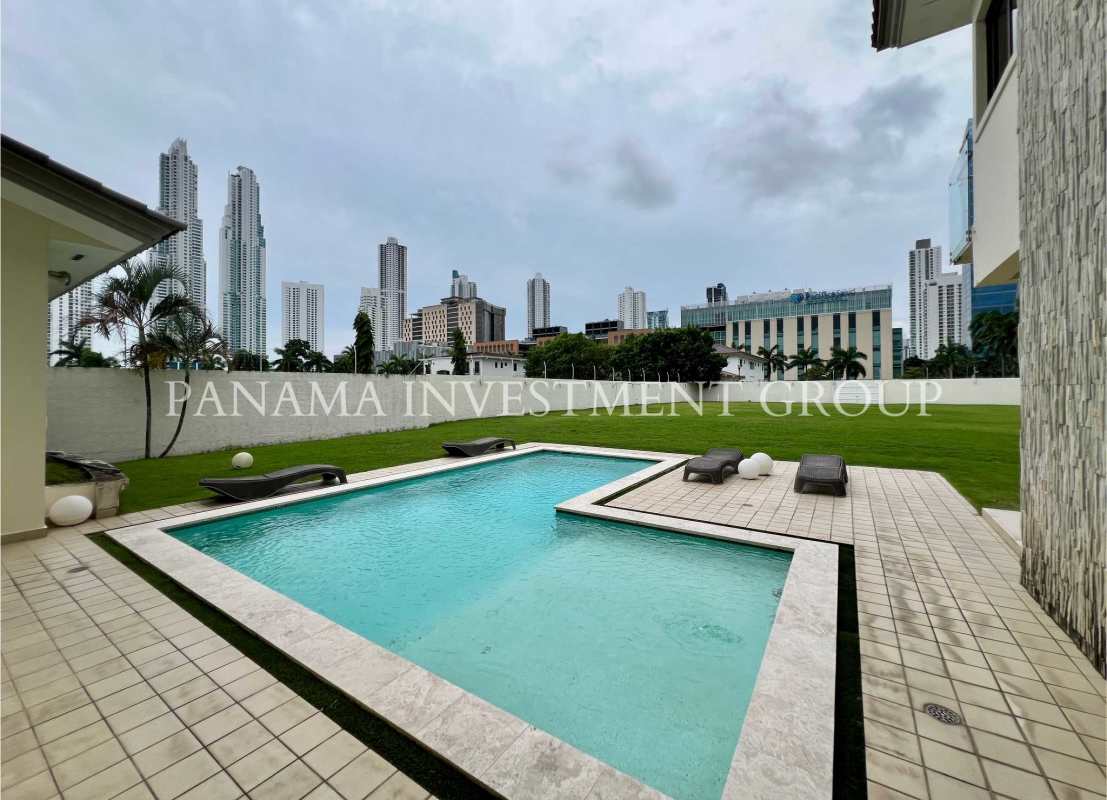 Modern backyard with swimming pool green lawn sun deck Costa del Este Panama