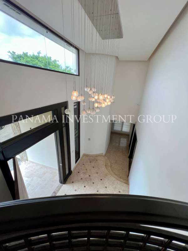 Modern double height entry foyer marble floors chandelier luxury villa Panama