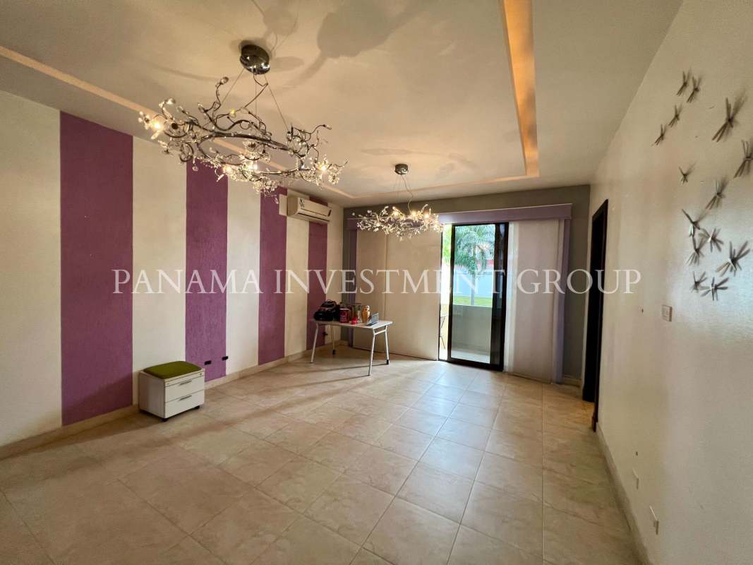 Modern living room striped accent wall sliding glass balcony Costa del Este Panama