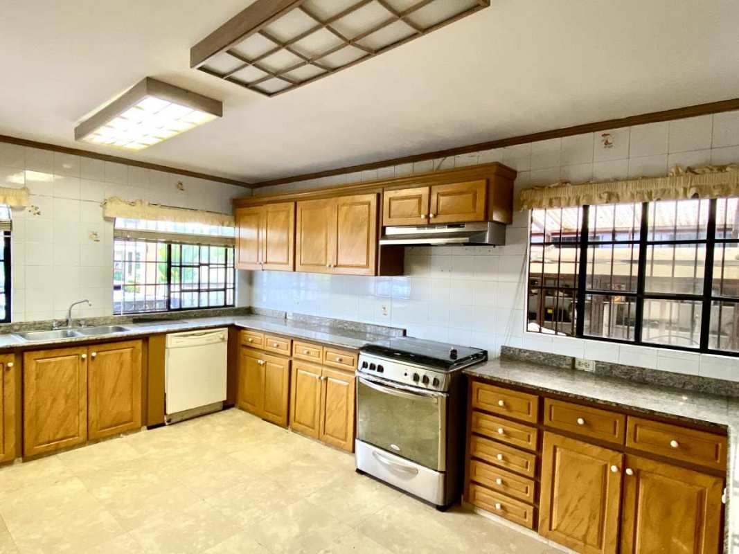 Traditional foyer entrance with double wrought iron doors, tile floors in Las Cumbres luxury house Panama