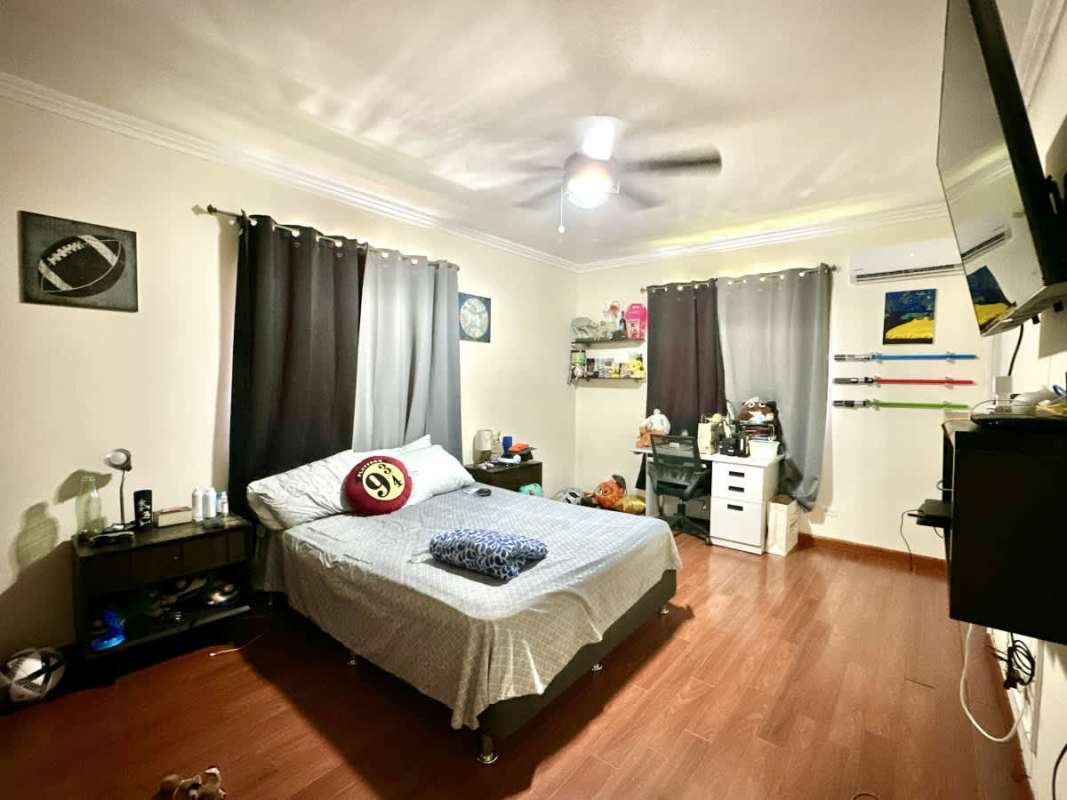Dining room with holiday decoration, green walls, large windows in villa Las Cumbres Panama