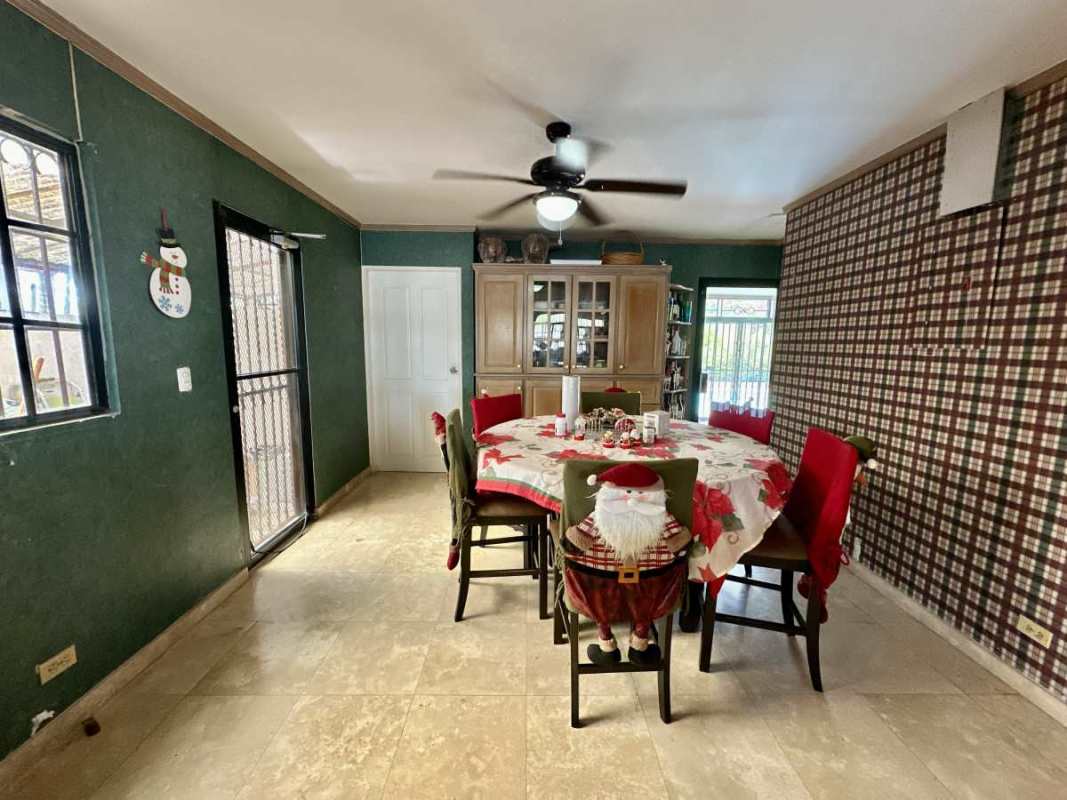 Outdoor swimming pool with patio, mountain backdrop in villa Las Cumbres Panama