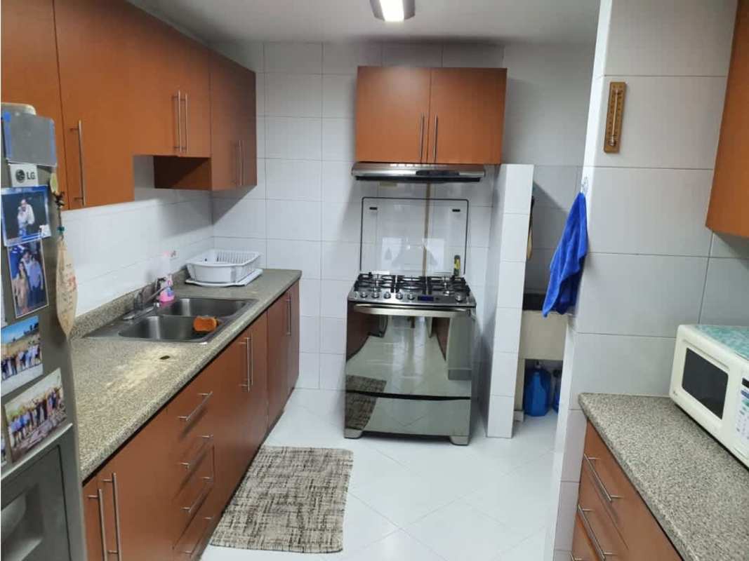 Kitchen with cabinetry, granite countertop, stove at PH Miraluz Punta Paitilla Panama