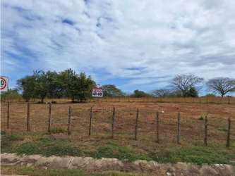Vacant fenced plot with trees next to paved road in rural Chitré Herrera Panama