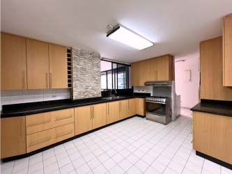 Modern kitchen with granite countertops and wood cabinetry in PH Crillon Punta Paitilla Panama City