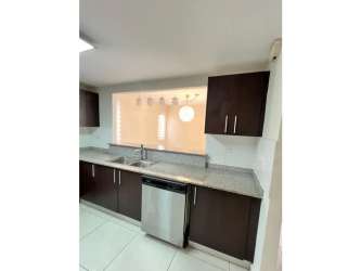 Contemporary kitchen with granite counters, wood cabinets and stainless steel appliances in Panama Pacifico