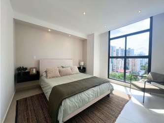 Modern bright kitchen with window, built-in stove, and cabinets PH Cranc Tower