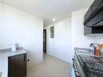 Minimalist hallway with built-in workspace and art at PH Cranc Tower