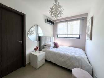 Modern bathroom vanity with circular mirror striped tiles Cranc Tower Panama