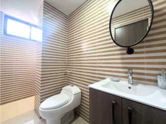 Bathroom featuring walk-in shower and striped tiled walls at PH Cranc Tower