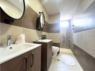 Contemporary bathroom with shower, striped tiles and mirror at PH Cranc Tower