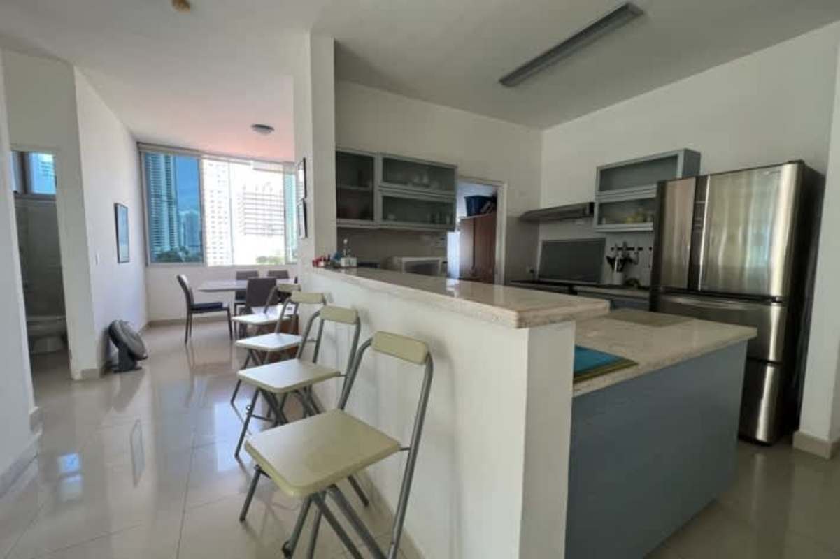 Modern kitchen with granite countertops, appliances, glass cabinets in San Francisco Bay Panama apartment