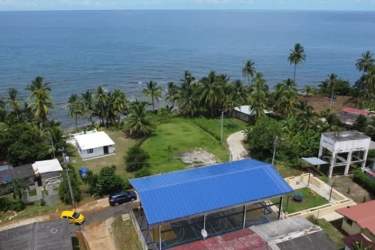 Aerial photo of beachfront land with palms and buildings Punta Grande Caribbean Panama