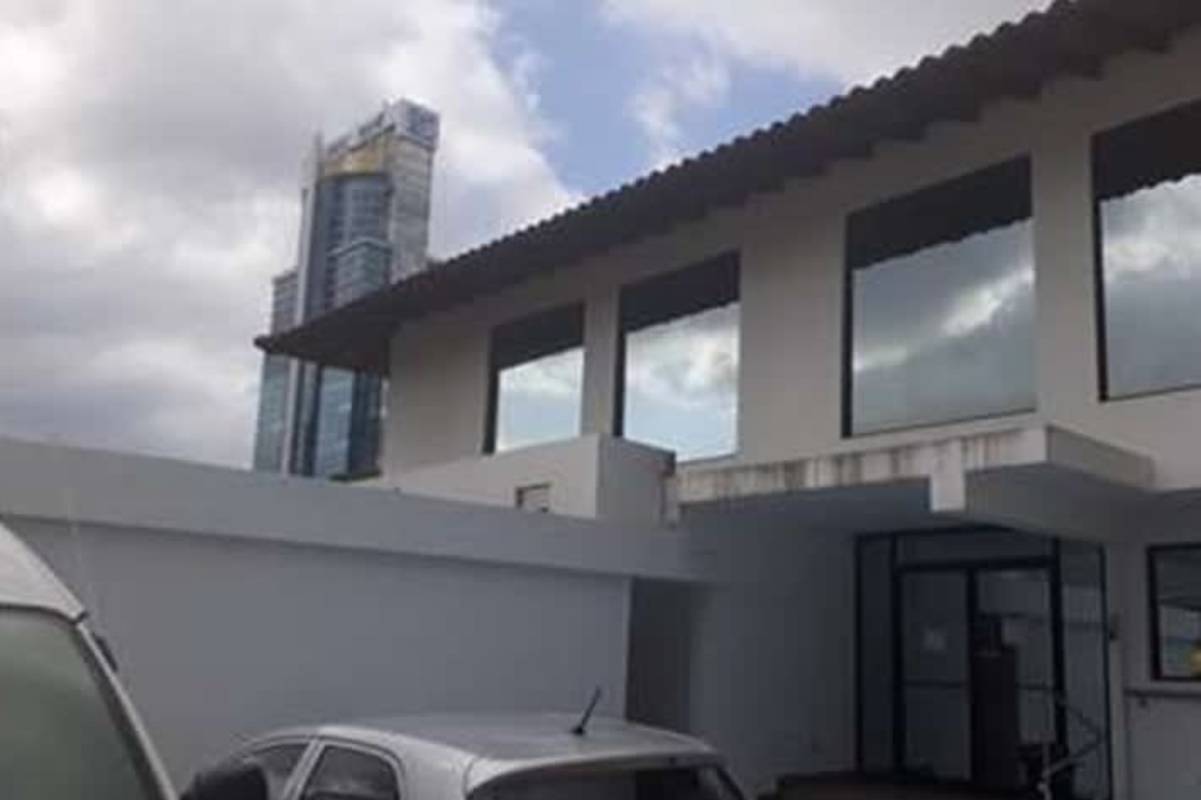 Reception area with glass doors and staircase in office building for rent Obarrio Panama City