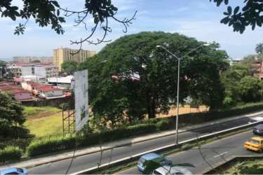 Triangular vacant commercial lot outlined in red near main roads and urban area Ancón Panama