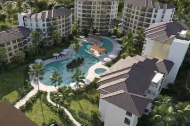 Aerial view beachfront towers and pool in Olas del Mar Playa Caracol Panama