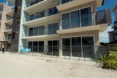 Balcony view from beachfront condos with lounge area overlooking Playa Caracol Panama