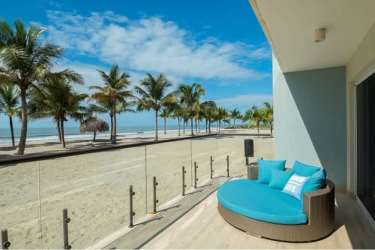Beachfront resort with pool palm trees at Playa Caracol Panama