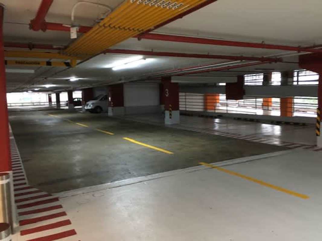 Shopping center interior with escalator, marble floors, stores and signage at Pacific Center Panama