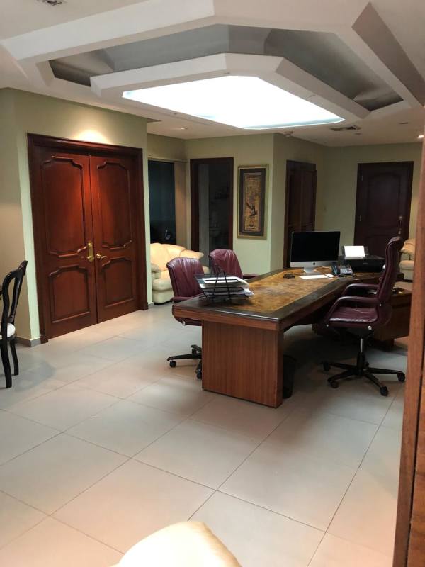 Traditional style executive office with large wooden desk at PH Omega Obarrio