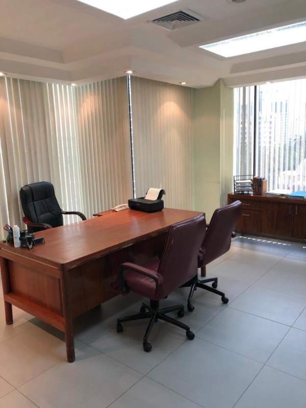 Private office featuring wood desk chairs large windows PH Omega Obarrio Panama
