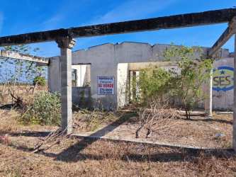 Rural Panama abandoned house frame with open lot and vegetation