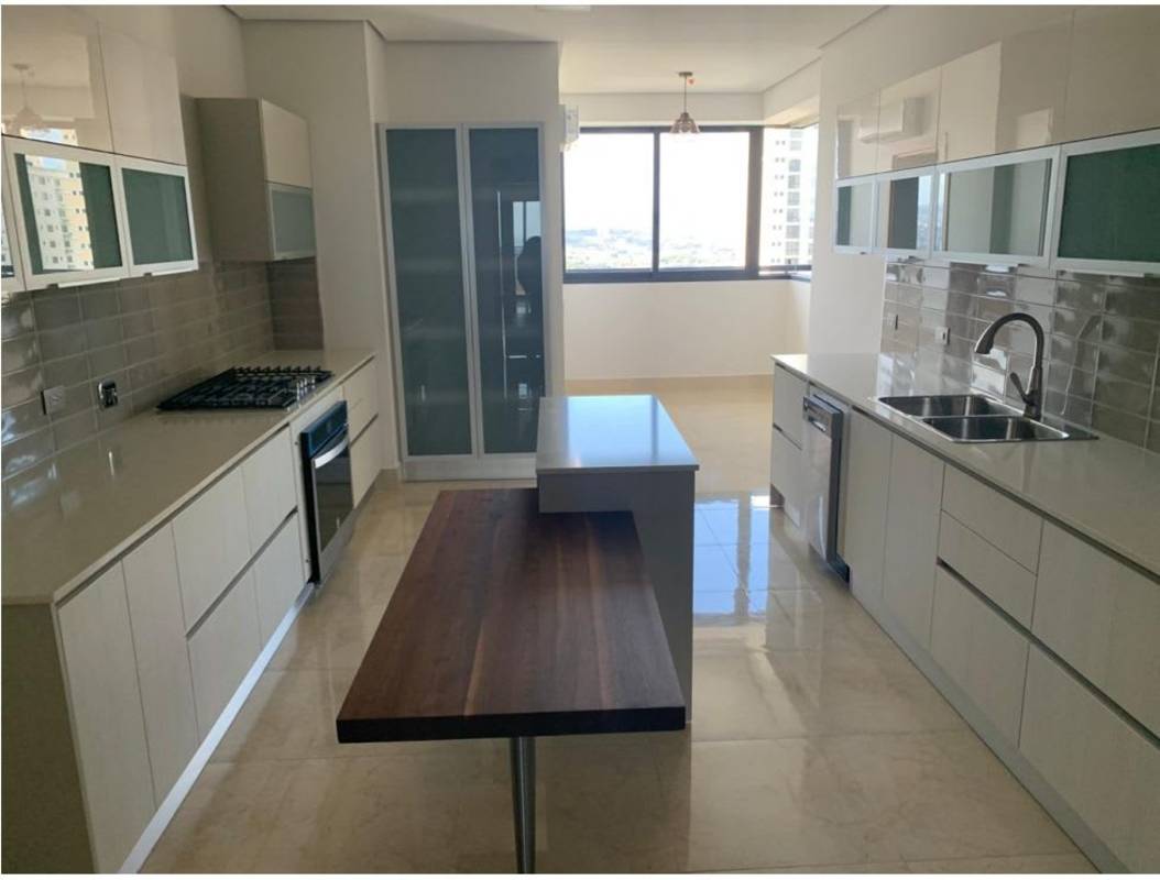 Primary bedroom with large windows ocean view and ensuite bathroom in PH Matisse Costa del Este Panama