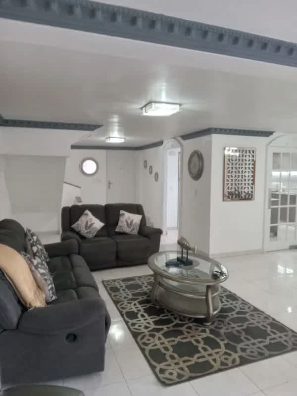 Spacious living room with sectional sofa, TV, ceramic floors in Altos del Panamá Panama