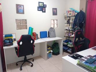 Bright office space with desks and shelving in Barrio Colon La Chorrera