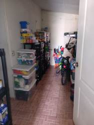 Functional laundry area with stacked washer dryer and sink in La Chorrera