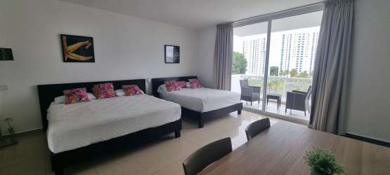 Kitchenette with appliances wood cabinets wash machine in studio Playa Blanca Resort Panama