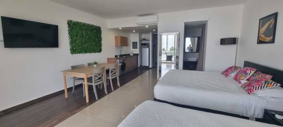 Sleeping space with beds balcony door lagoon view Playa Blanca Resort studio Panama