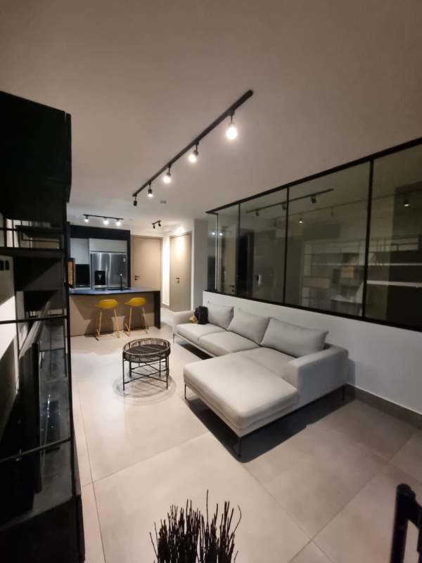 Modern minimalist bedroom with large windows and balcony overlooking Panama City skyline at PH Victory Wellness