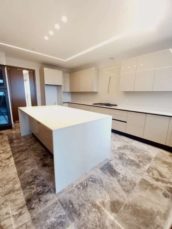 High-end Italian kitchen with quartz island, premium appliances and marble flooring in Empire Residences Panama